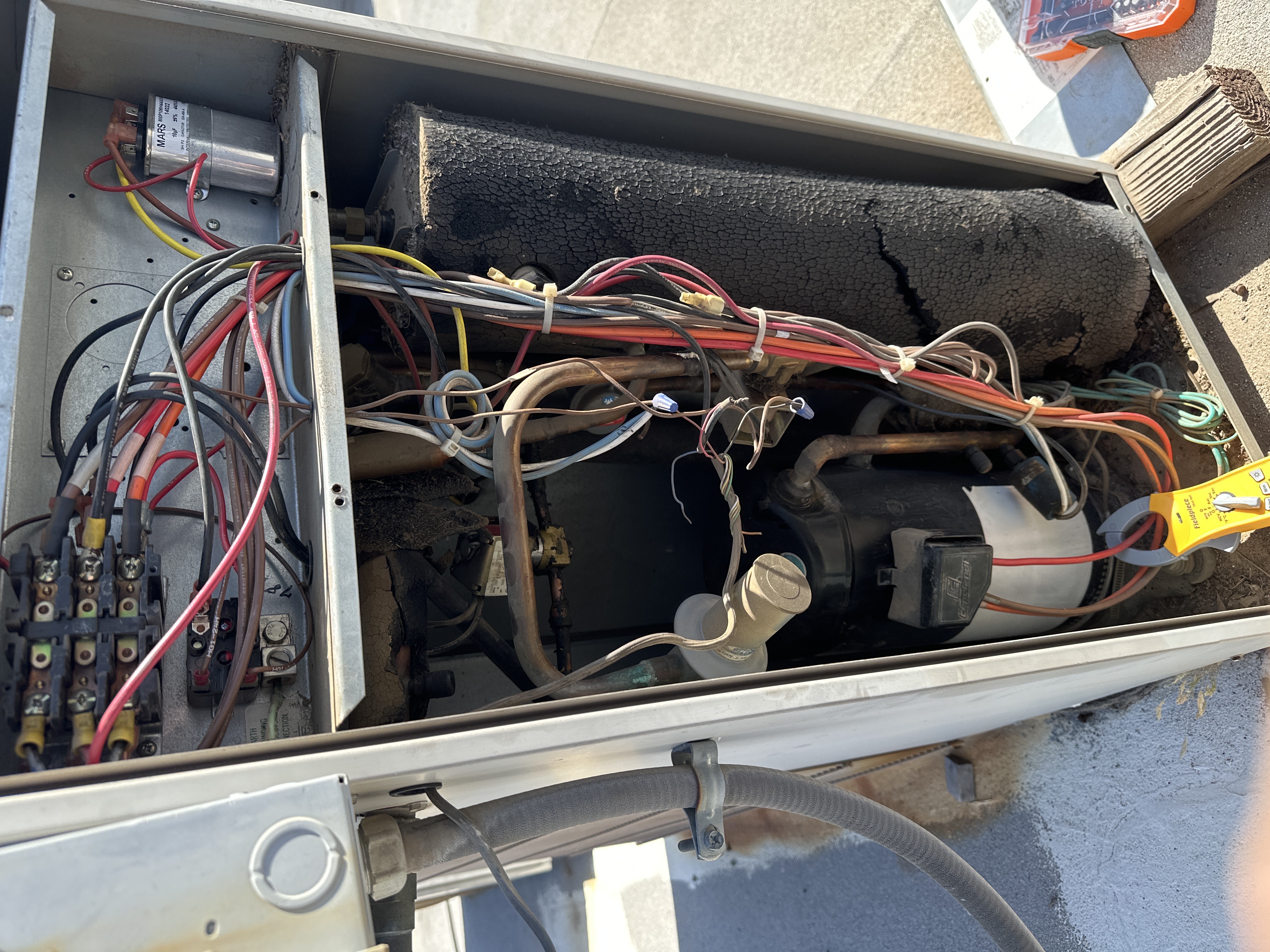 The internal wiring of an HVAC unit during a diagnostic check.